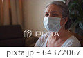 Pandemic. Senior Woman do office job at home wearing protective mask 64372067