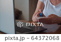 Quarantine. Woman cleaning her laptop at the home. Using antibacterial gel 64372068