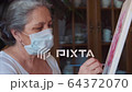 Coronavirus artist painting at home wearing hygienic mask to prevent infection 64372070