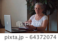 Coronavirus. Quarantine. Senior Woman finish freelance work at home 64372074