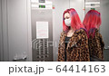 Beautiful young asian girl medical mask ride elevator apartment house 64414163