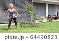 Senior woman is exercising by fitness rubber 64490823