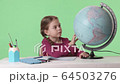 Child girl showing place on the globe 64503276