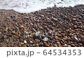 Slow motion of waves lapping the pebbles on Brighton beach, England, United Kingdom 64534353