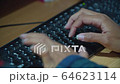 Women's hands typing on computer keyboard 64623114