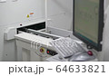 Engineer monitors and adjusts the surface mount conveyor for LEDs 64633821