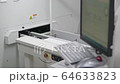 Engineer monitors and adjusts the surface mount conveyor for LEDs 64633823