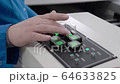 Engineer monitors and adjusts the surface mount conveyor for LEDs 64633825