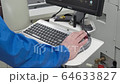 Engineer monitors and adjusts the surface mount conveyor for LEDs 64633827