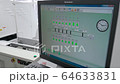 Engineer monitors and adjusts the surface mount conveyor for LEDs 64633831
