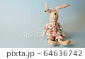 Easter bunny with colorful pastel decor eggs falling on blue background, holiday concept 64636742