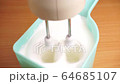 Beating with mixer the egg whites to a light froth  4K 64685107