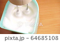 Beating with mixer the egg whites to a light froth  4K 64685108
