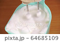 Beating with mixer the egg whites to a light froth  4K 64685109