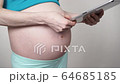 Pregnant woman using digital tablet 4K 64685185