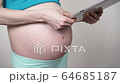 Pregnant woman using digital tablet 4K 64685187