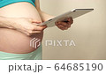 Pregnant woman using digital tablet 4K 64685190