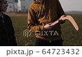 young couple in love together launch a boomerang in a field 64723432