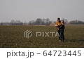 young couple in love together launch a boomerang in a field 64723445