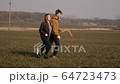 young couple in love together launch a boomerang in a field 64723473