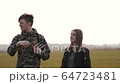 young couple in love together launch a boomerang in a field 64723481