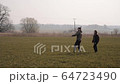 young couple in love together launch a boomerang in a field 64723490