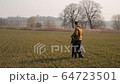 young couple in love together launch a boomerang in a field 64723501