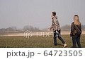 young couple in love together launch a boomerang in a field 64723505