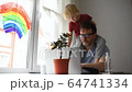Man working from home with laptop during quarantine. Home office and parenthood at same time. Exhausted parent with hyperactive child. Chaos with kids during isolation 64741334