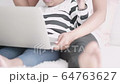 Mother teaches children to learn through a laptop. 64763627