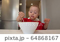 Little baby girl eat milk porridge. Baby eat milk porridge 64868167