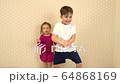 brother and little sister dance at home to fun music 64868169