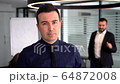 Successful business man leading a corporate team 64872008