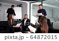Smiling millennial male coach or presenter make flip chart presentation ask question during work training 64872015