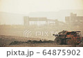 Mining trucks unloads slag at dawn. Operating heavy equipment  in real time. 64875902