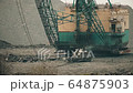 Workers Repairing large excavator bucket. Heavy machinery background for design. 64875903