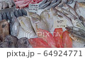 Slow motion zoom out of assortment of fresh fish, including Butterfish and Emperor fish, displayed on ice in a UK fishmonger 64924771