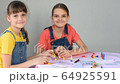 Two girlfriends at home at the weekend play board games and looked at the frame 64925591