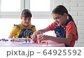 Two girls play board games joyfully and cheerfully 64925592