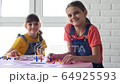 Two girls play board games and have fun looking at the frame 64925593