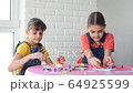 Two girls play board games and looked at the frame 64925599