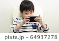 A boy using a smartphone 64937278
