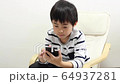 A boy using a smartphone 64937281