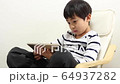 A boy using a tablet 64937282