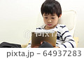A boy using a tablet 64937283