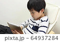 A boy using a tablet 64937284