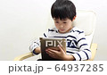 A boy using a tablet 64937285