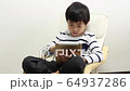 A boy using a tablet 64937286