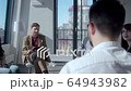 Rear view of young man being interviewed in large IT company 64943982