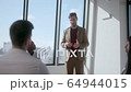 Young handsome caucasian coach tells mixed race audience 64944015